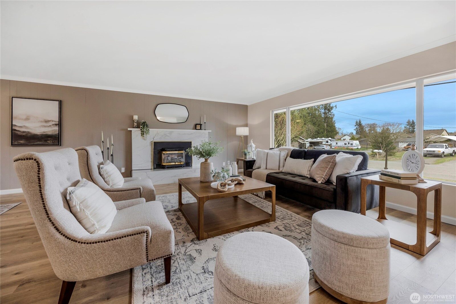 Renovated living room with refreshed fireplace and hardwood flooring